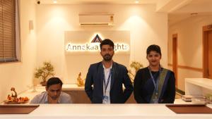 a group of men standing in front of a counter at Annekaa Heights in Vrindāvan