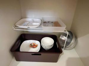 a small refrigerator with a plate and a donut in it at 一心館sakura401 in Wada +13 photos
