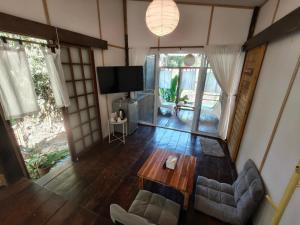 a living room with a couch and a table at pannaburee resort in Ban Khanong Phra Klang (1)