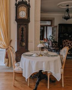 a table with a grandfather clock in a room at Casa do Fontão in Amarante