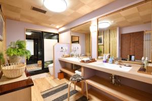 a bathroom with two sinks and a large mirror at Seikoro Ryokan - Established in 1831 in Kyoto +45 photos