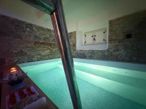 a view of a swimming pool from a glass window at Villino Eleonora & Spa in Parghelia