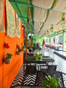 a restaurant with tables and chairs and people in the background at west water hotel in Vang Vieng +33 photos