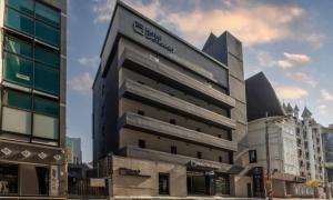a building with a sign on the front of it at Cheongju Hotel Dictionary in Cheongju