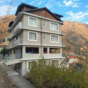 a building on the side of a mountain at Serai Habitat in Solan