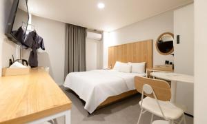 a hotel room with a bed and a desk at Cheongju Hotel Dictionary in Cheongju +60 photos
