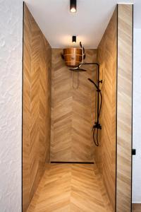 a room with a wooden wall with a bowl on the wall at Berek Kúria in Sonkád