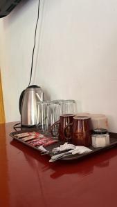 a tray with glasses and utensils on a table at Villa Consolacion Resort in General Luna