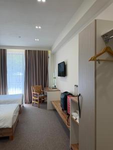 a hotel room with a bed and a desk at TES Hotel in Osh