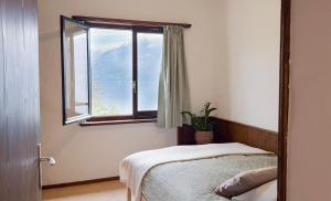 a bedroom with a bed and a window at La Finestra sul lago in Brissago +112 photos