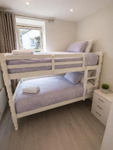two bunk beds in a room with a window at Unit 5 Stunning Oceanview Apartment in Cobh