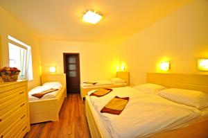 a bedroom with two beds with towels on them at Apartment Bartek Ski Rental in Demanovska Dolina