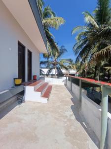 a house on the beach with palm trees at Shyams homestay MV in Malpe