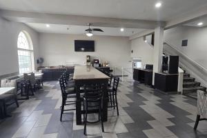 a large room with a kitchen and a table and chairs at Super 8 by Wyndham Kansas City in Kansas City