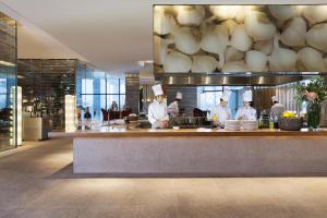 a group of chefs preparing food in a kitchen at Grand Hyatt Incheon in Incheon