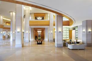 a lobby of a building with a large arch at Grand Hyatt Incheon in Incheon +73 photos