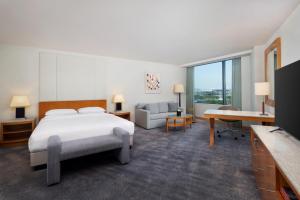 a large hotel room with a bed and a couch at Grand Hyatt Incheon in Incheon