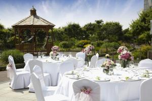 a group of tables with white chairs and a gazebo at Grand Hyatt Incheon in Incheon