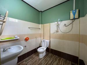 a bathroom with a toilet and a sink at Ariya Garden Home in Chumphon +27 photos