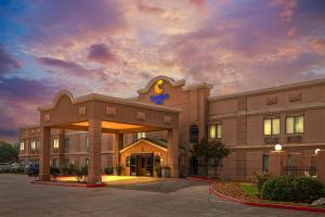 a hotel building with a sign on top of it at Comfort Inn North Conroe in Conroe