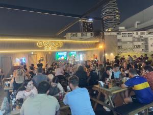 a crowd of people sitting at tables in a restaurant at O'Shea's Sukhumvit Bangkok in Klong Toi