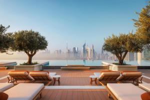 a rooftop patio with lounge chairs and a view of the city at One&Only One Za'abeel in Dubai +190 photos