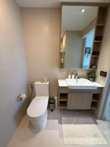 a bathroom with a toilet and a sink at Avrora Laguna Residences Sky Park in Ban Thalat Choeng Thale +12 photos