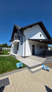 a white house with a porch and a patio at House in Hudum - Botoșani in Hudum
