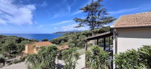 a view of the ocean from a house at Villa Oleandro in Capoliveri