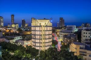 a view of a tall building at night at 65 Hotel, Rothschild Tel Aviv - an Atlas Boutique Hotel in Tel Aviv