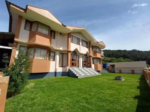 a large house with a lawn in front of it at Winterfeel Bellmount by Neon Nest in Ooty +55 photos