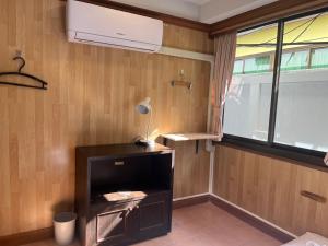 a room with a heater and a lamp on a wall at Basic Simple Family 3 Bedroom for 4 Person in Nathon Bay