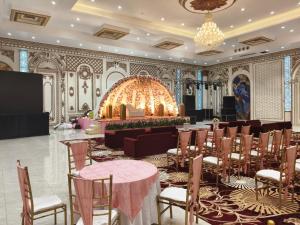a banquet hall with tables and chairs in a room at JPS Resort with Swimming Pool Near IMT Manesar in Gurgaon +43 photos