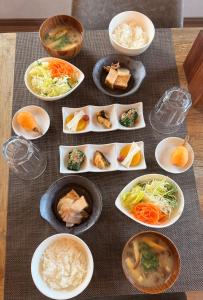 a group of plates of food on a table at Guesthouseあいみ in Amami