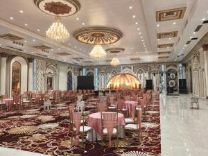 a banquet hall with tables and chairs in a room at JPS Resort with Swimming Pool Near IMT Manesar in Gurgaon