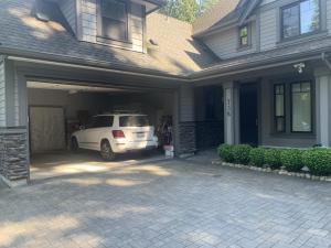 a white car is parked in a garage at Vancouver Austin Guesthouse in Coquitlam