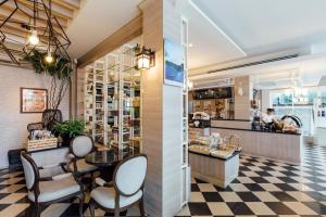 a restaurant with chairs and a counter in a store at Kameo Grand Hotel & Serviced Apartment, Rayong in Rayong