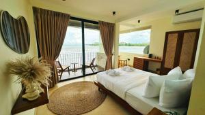 a bedroom with a bed with a view of the ocean at Meli Beach in Galle