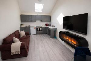 a living room with a couch and a fireplace at Unit 4 Tranquil Harbourside Retreat- Central Location in Cobh