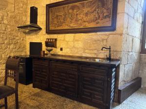 a sink in a room with a stone wall at Château de Saint Maurice in La Peyrouse +97 photos