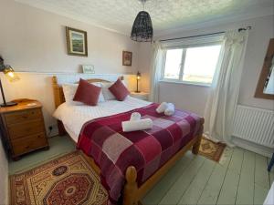 a bedroom with a bed with two white boxes on it at 11 Penygroes in Llantrisant