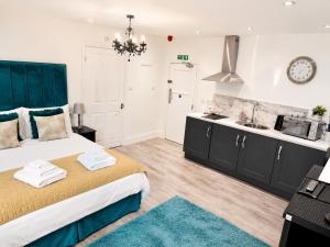 a bedroom with a bed and a kitchen with a sink at Market View 1 in Hexham
