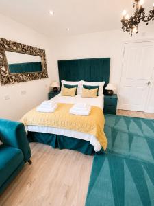 a bedroom with a large bed and a mirror at Market View 1 in Hexham