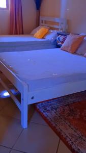 two beds sitting next to each other in a room at Pebs one bedroom apartment in Mombasa