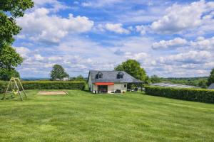 a large yard with a house and a playground at Gite le Martalou in Lacapelle-Viescamp