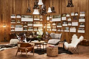 a room with chairs and tables and pictures on the wall at Ecrin Blanc Resort Courchevel - Aquapark in Courchevel