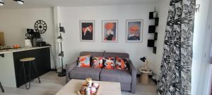 a living room with a couch and a table at Studio de l'Armançon in Semur-en-Auxois