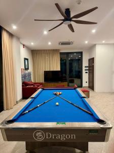 a pool table in a living room with a ceiling fan at Villa Flamingo Hải Tiến in Thanh Hóa +10 photos