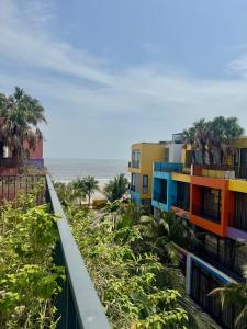 a row of colorful buildings next to the beach at Villa Flamingo Hải Tiến in Thanh Hóa