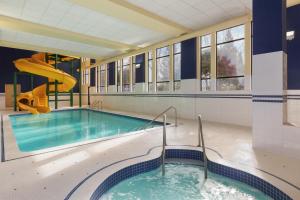 a swimming pool with a slide in a building at Hampton Inn & Suites by Hilton Langley-Surrey in Surrey
